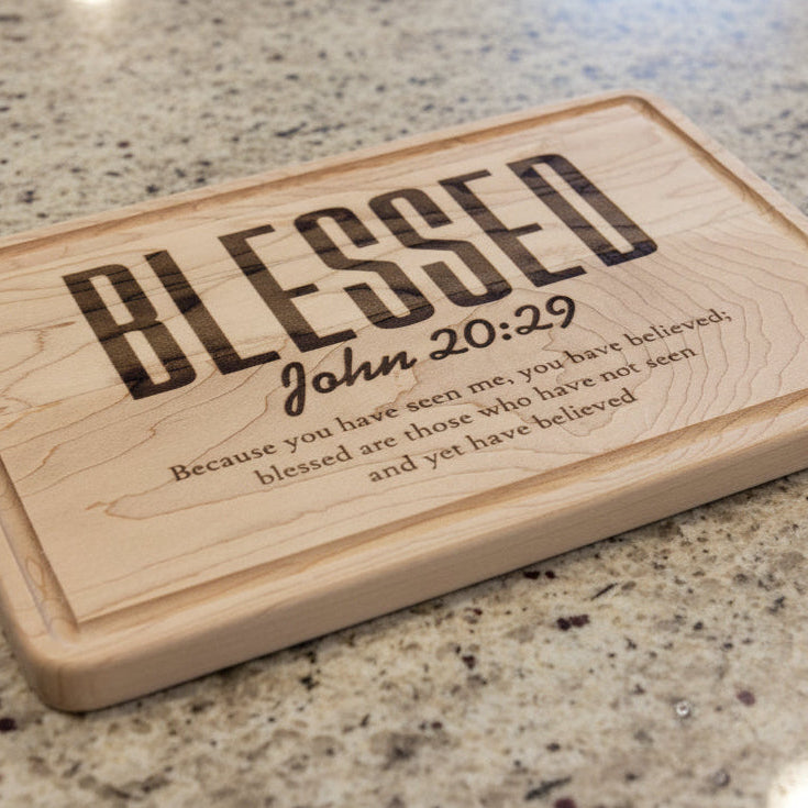Wooden plaque with 'Blessed' text and Bible verse on a white background