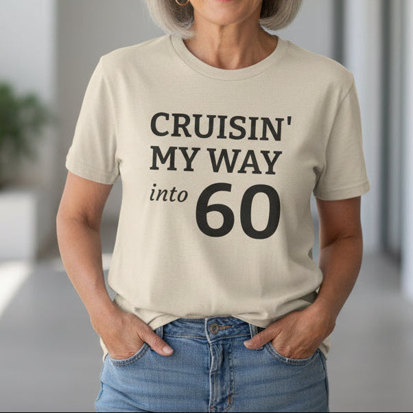 Beige t-shirt with text 'Cruisin' My Way into 60' on a white background