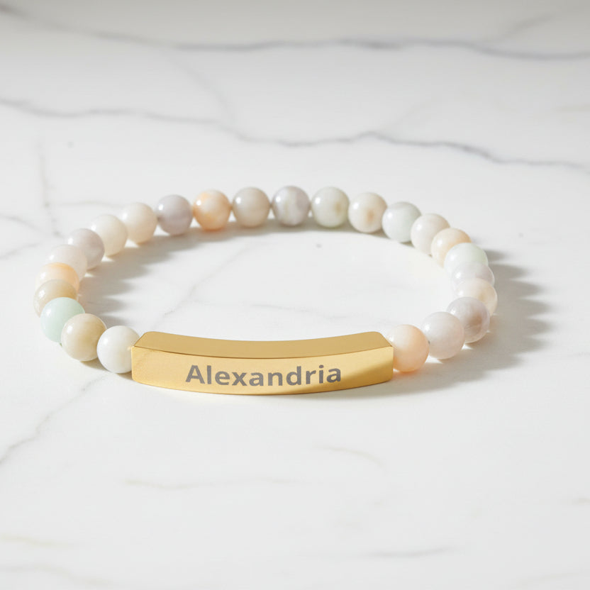 Beaded bracelet with a gold tag displaying 'Alexandria' on a white background