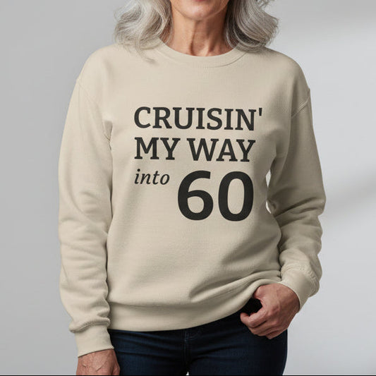 Beige sweatshirt with text 'CRUISIN' MY WAY into 60' on a white background