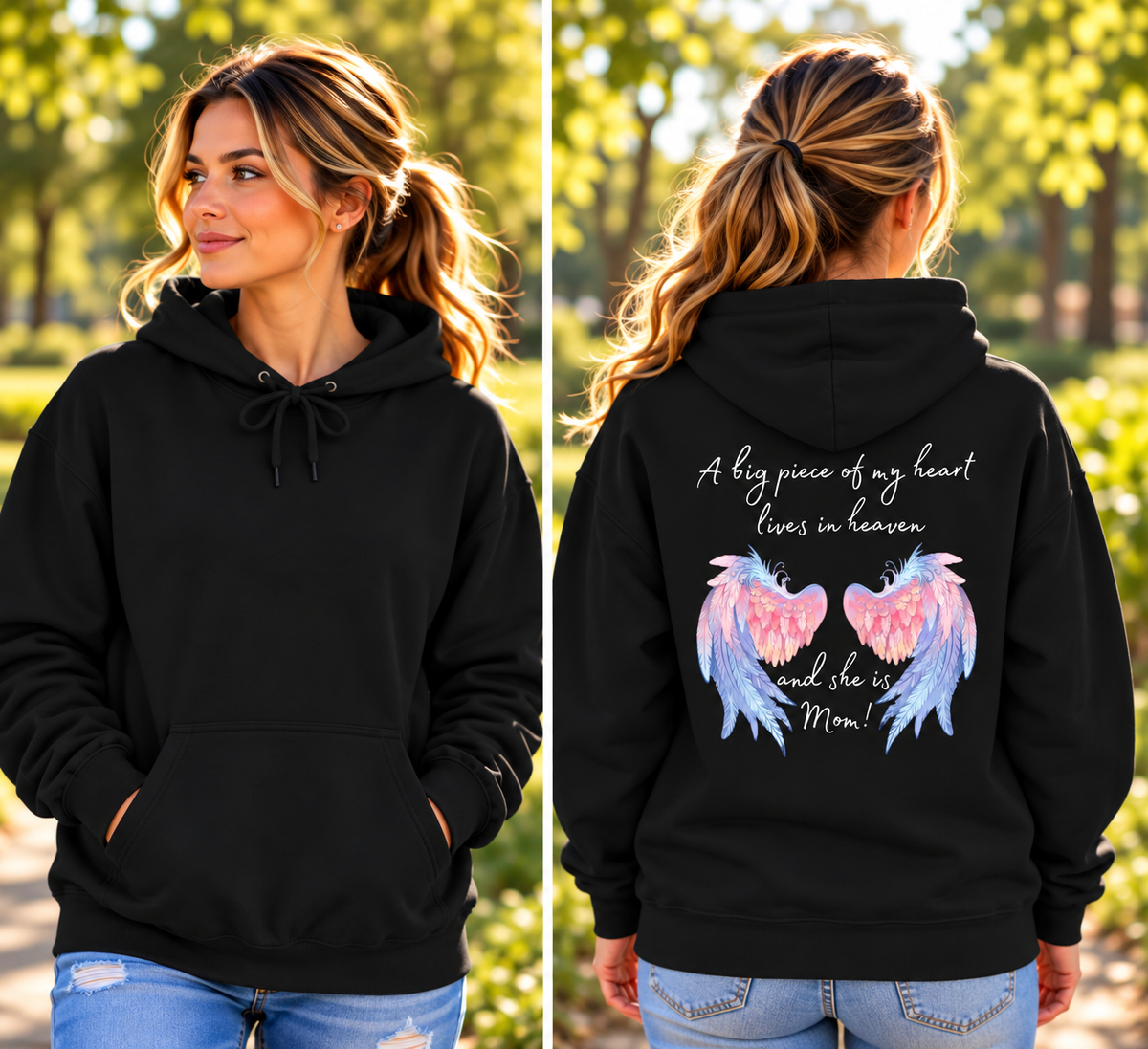 A woman modeling a black pullover hoodie in an outdoor park setting, shown from both the front and back. The front is plain black, while the back features a graphic with pink and blue angel wings and the text 'A big piece of my heart lives in heaven and she is Me!'.