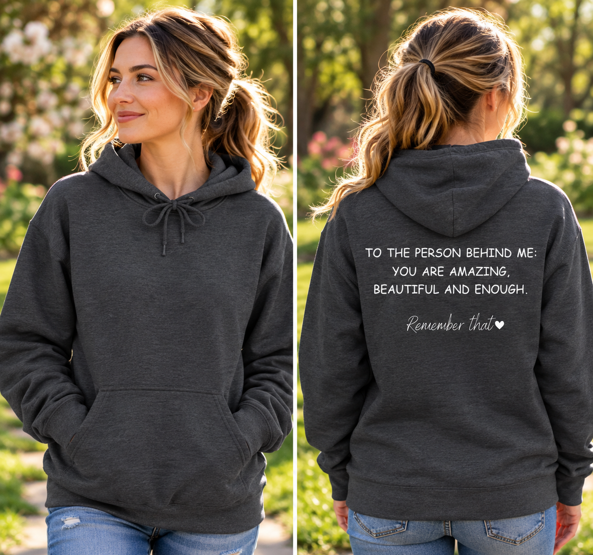A woman modeling a dark charcoal gray hoodie in an outdoor garden setting, shown from both the front and back. The front view shows the drawstring hood and kangaroo pockets, while the back view features white printed text that reads, 'TO THE PERSON BEHIND ME YOU ARE AMAZING, BEAUTIFUL AND ENOUGH.