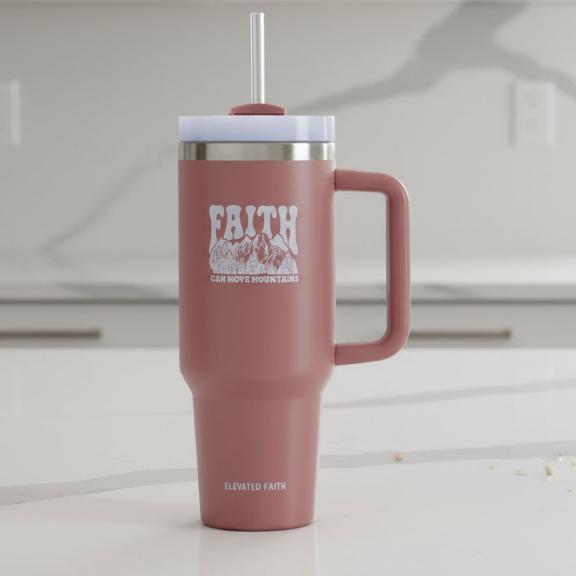 Pink insulated mug with handle and straw lid on a white background