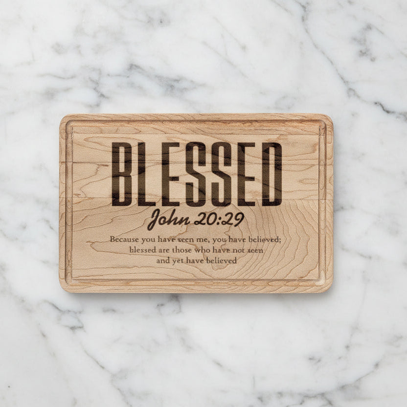Wooden plaque with 'Blessed' text and Bible verse on a white background