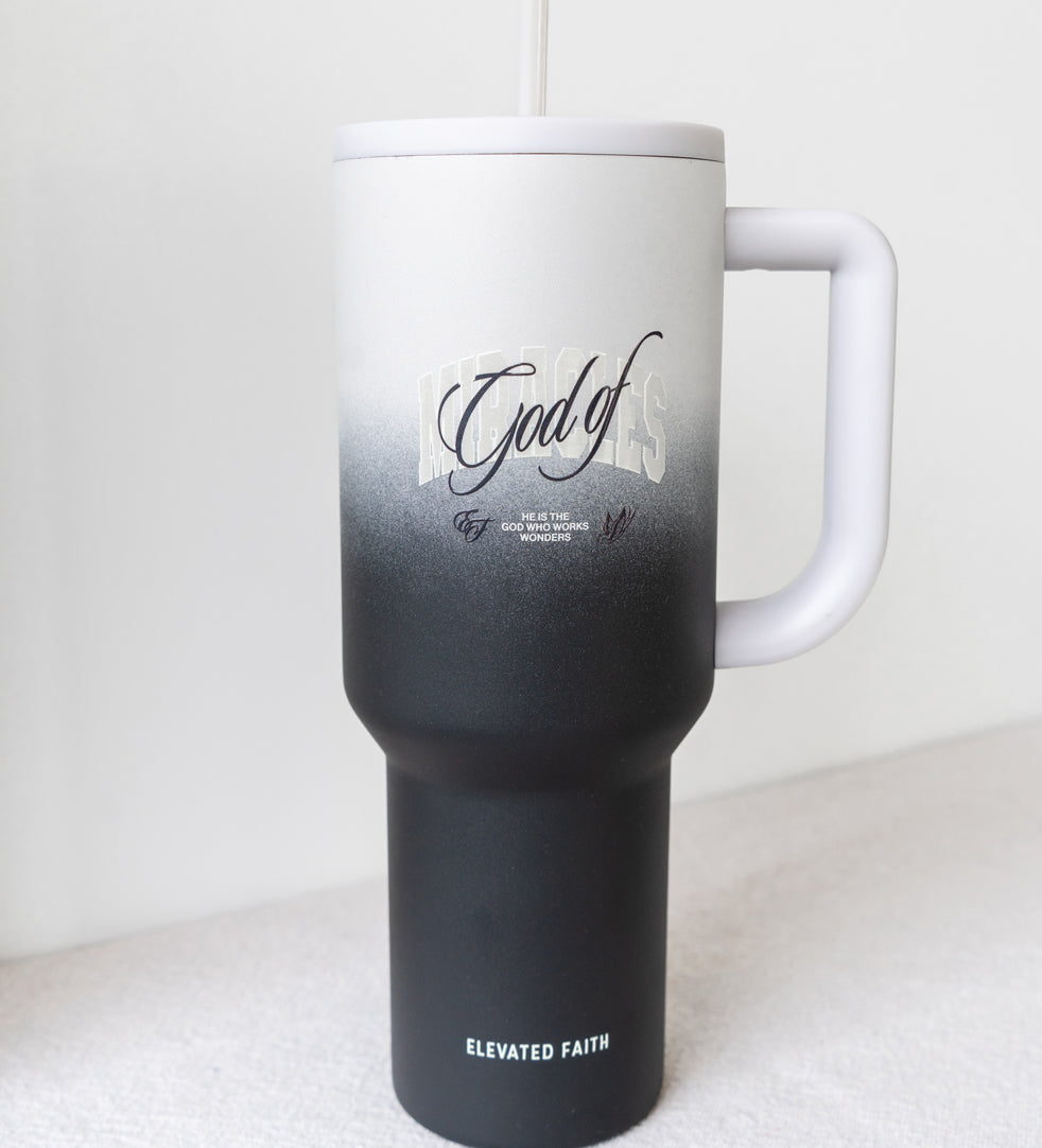 Black and white insulated tumbler with handle on a white background