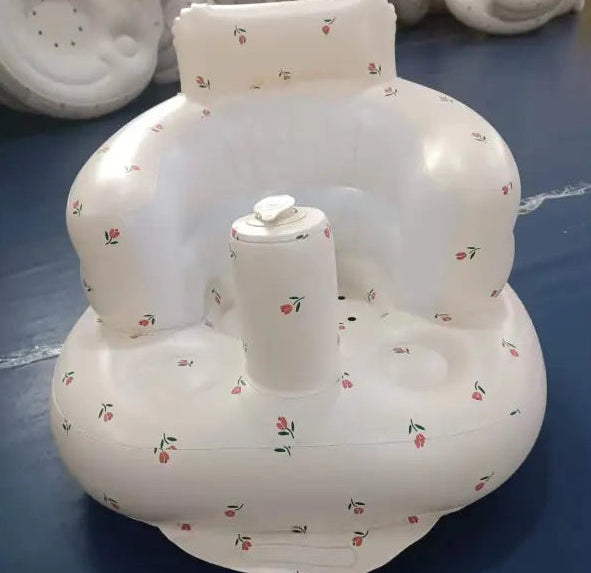 White inflatable baby seat with floral pattern on a blue surface
