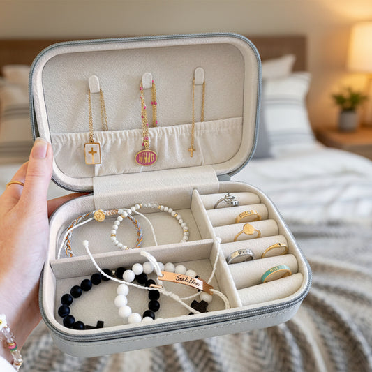Jewelry case with various necklaces and bracelets on a beige background
