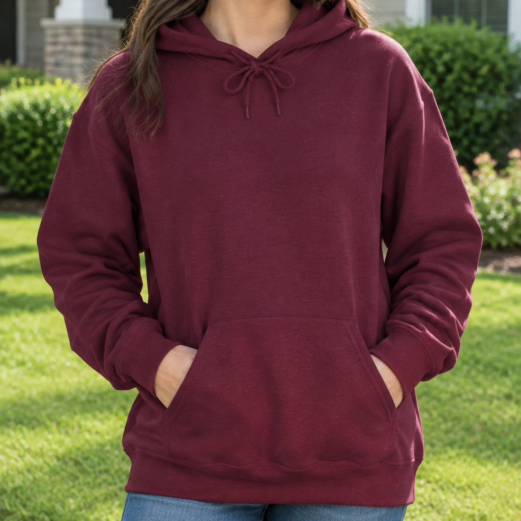 A person wearing a plain pullover hoodie in a heathered slate blue color, shown from the neck down against a solid white background.