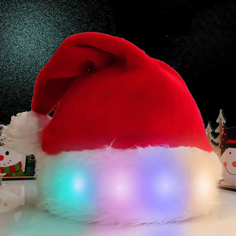 Red LED Santa hat on a dark background with Christmas decorations.