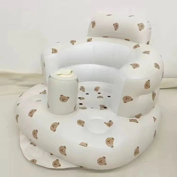 White inflatable baby seat with bear pattern on a white background